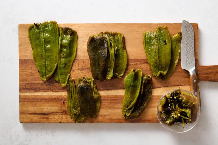 Preparing the charred poblano peppers