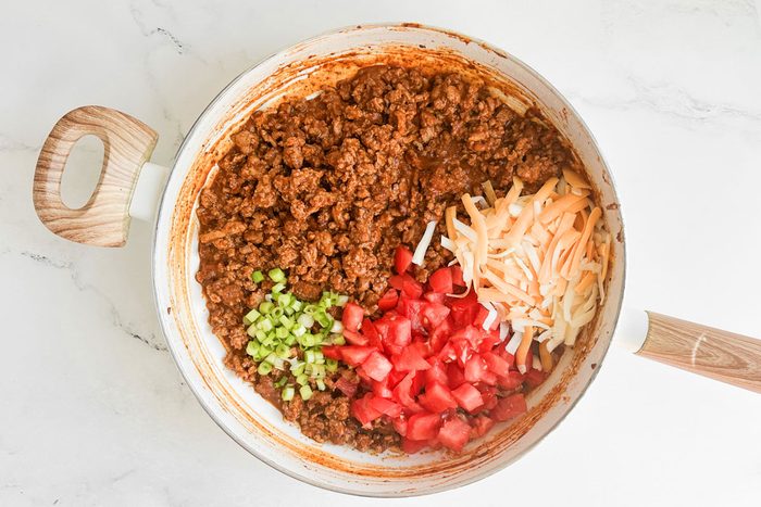 Filling for Taste of Home Chili Stuffed Poblano Peppers in a white skillet