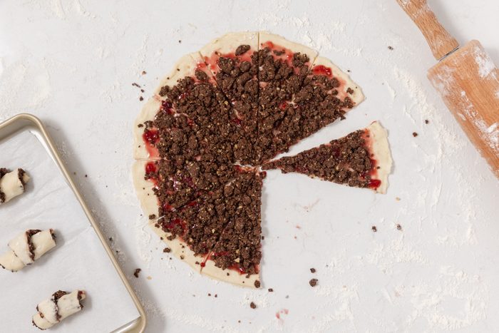 Chocolate rugelach being assembled and rolled.