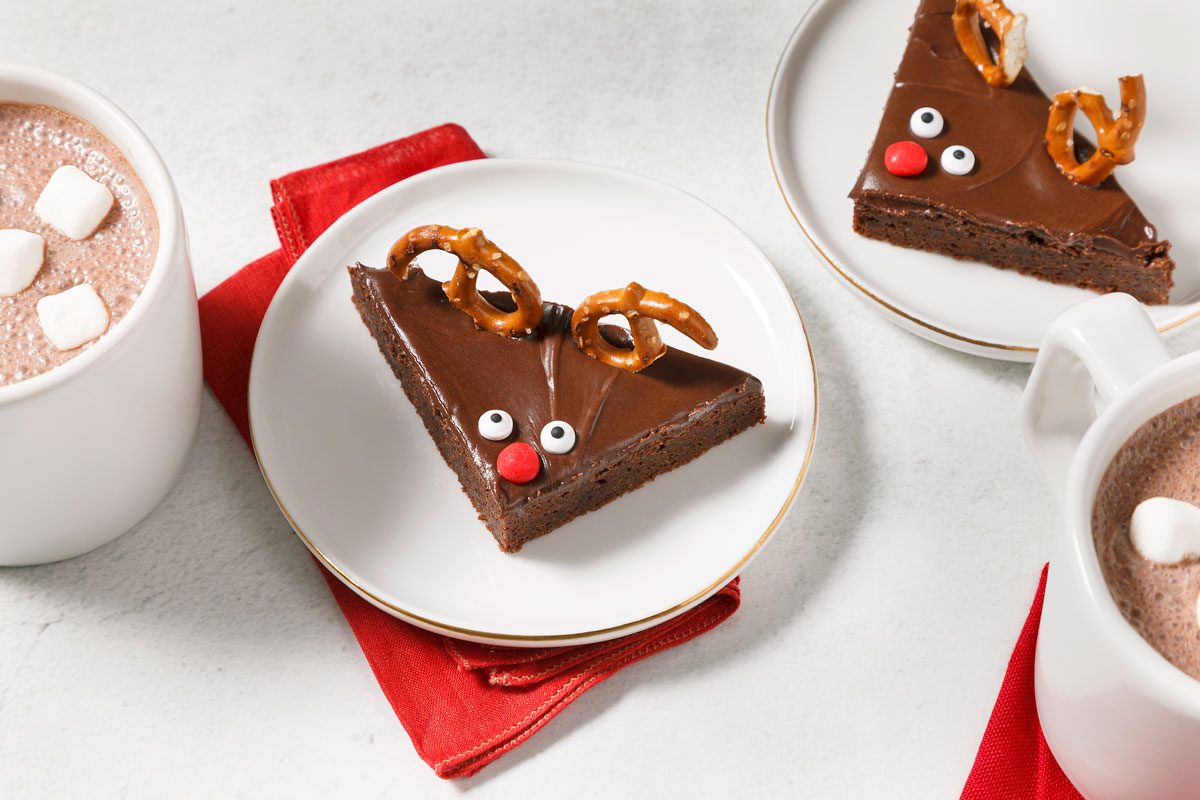 Reindeer Brownies plated, cups of hot cocoa nearby