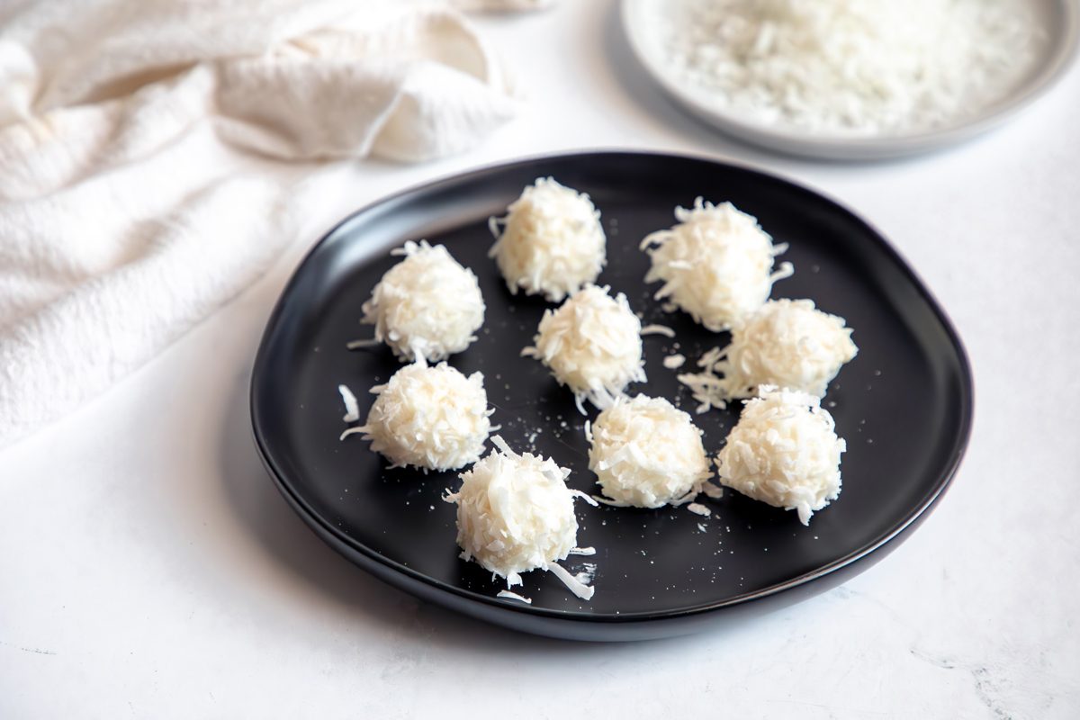 Beauty shot for Taste of Home Coconut Snowballs, with additionall shredded coconut in the corner.