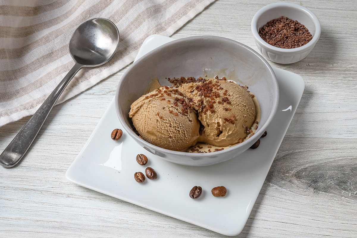 Coffee ice cream in a bowl with sprinkles.