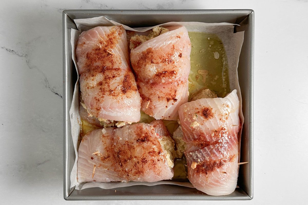 Unbaked Taste of Home Crab Stuffed Tilapia in a square baking pan