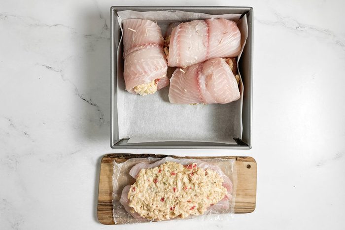 Unbaked Taste of Home Crab Stuffed Tilapia in a square baking pan