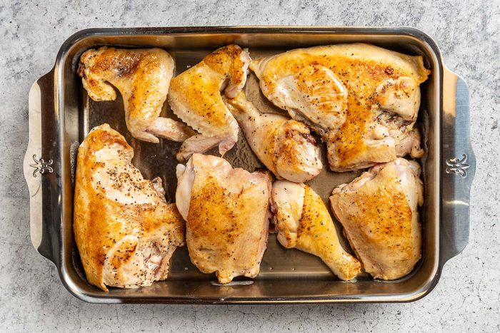 Taste of Home Cranberry Chicken Recipe photo of the browned chicken in a greased 9 x 13 baking dish.