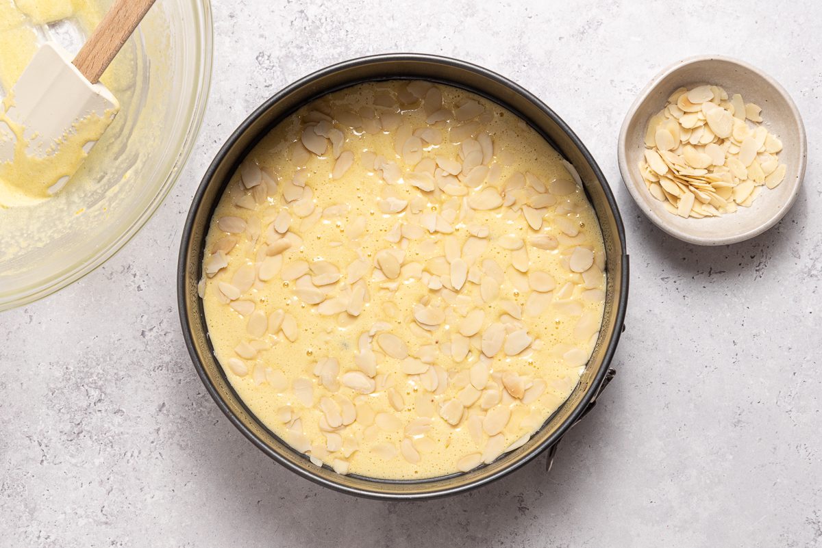 Cranberry Orange Cake In Pan Sprinkled With Almonds