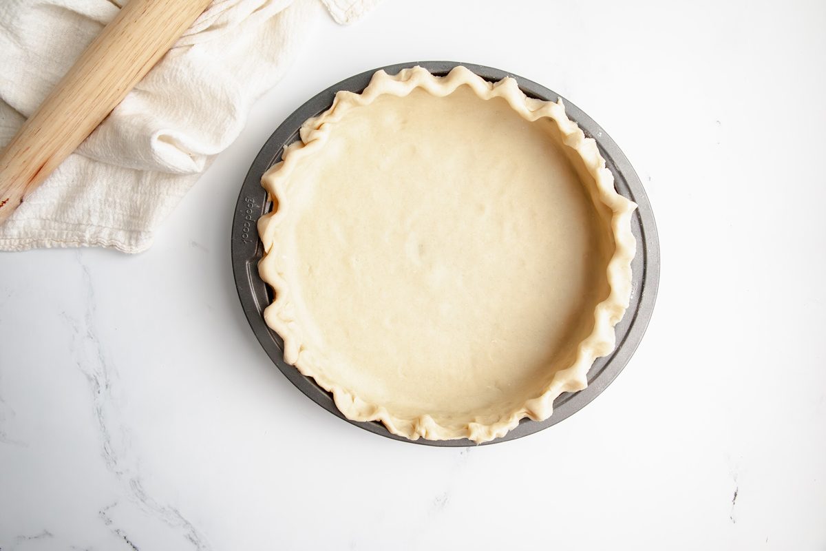 Overhead shot for Taste of Home Fudge Pie, unbaked crust in a pie tin.