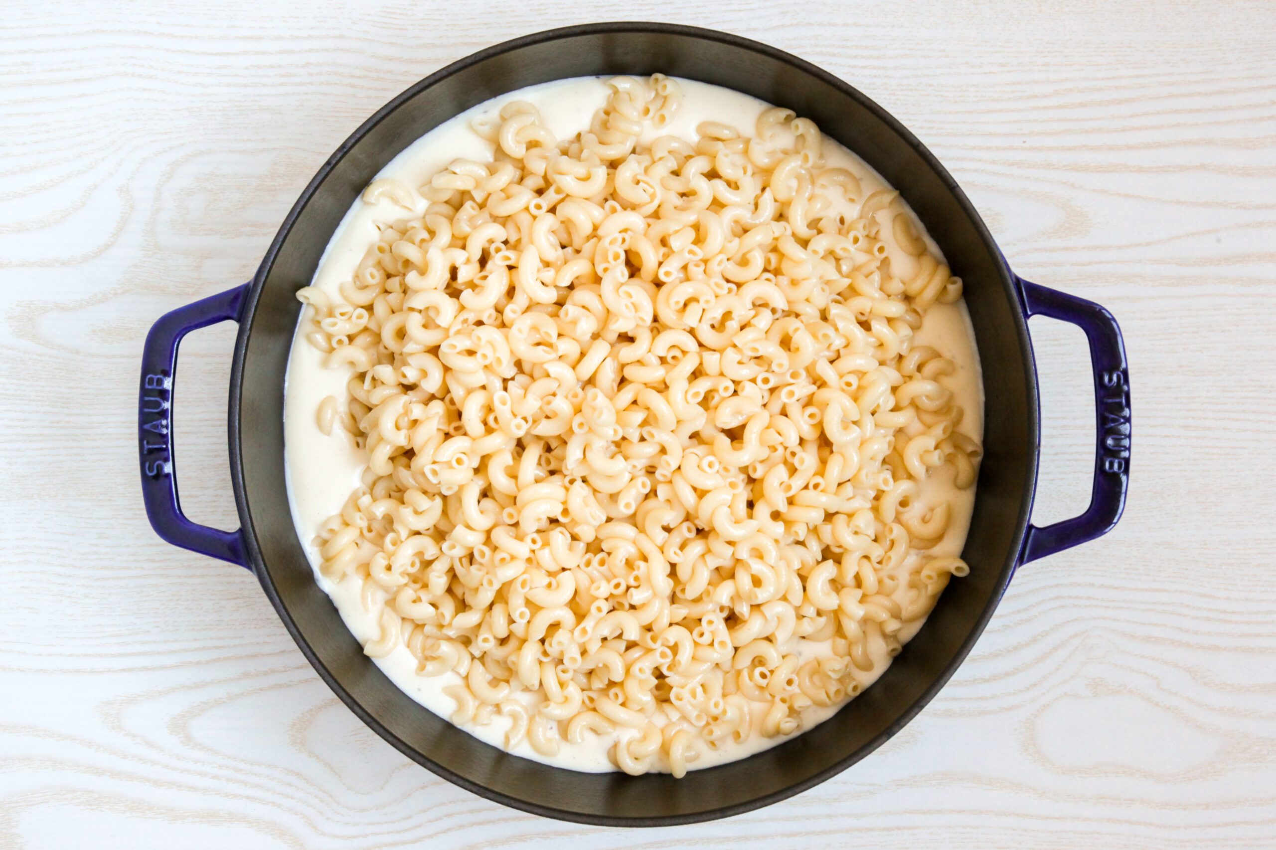 Adding macaroni to cheese sauce