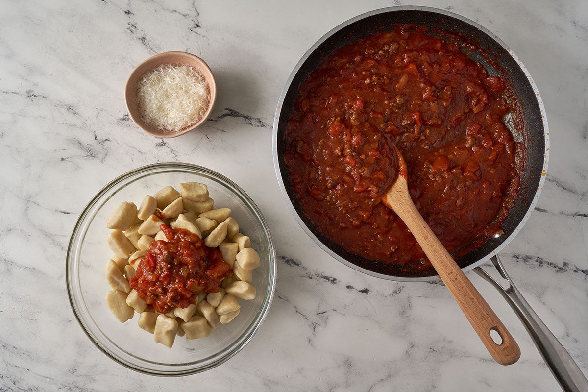 Cook the gnocchi in boiling water until they float, then gently stir them with the beef tomato sauce and top with Parmesan for serving in this Gnocchi Bolognese by Taste of Home.