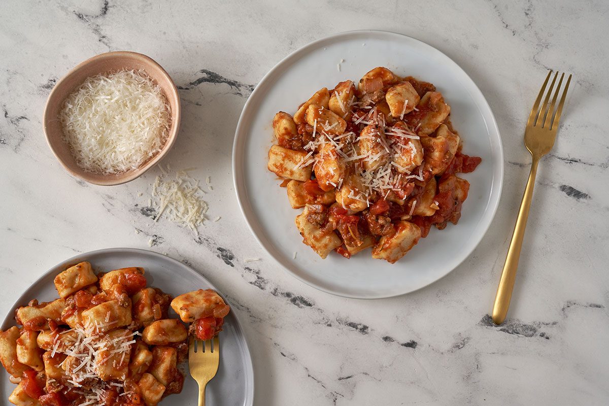 A full view of the Gnocchi Bolognese, topped with freshly grated Parmesan and served hot, by Taste of Home.