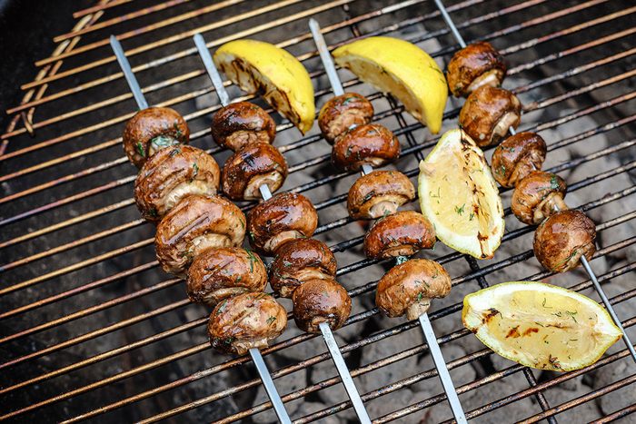 Grilling the mushrooms and lemon wedges.
