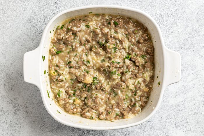 Taste of Home Hamburger and Rice Hot Dish photo of adding all the ingredients ot a 1.5 quart bakind dish.