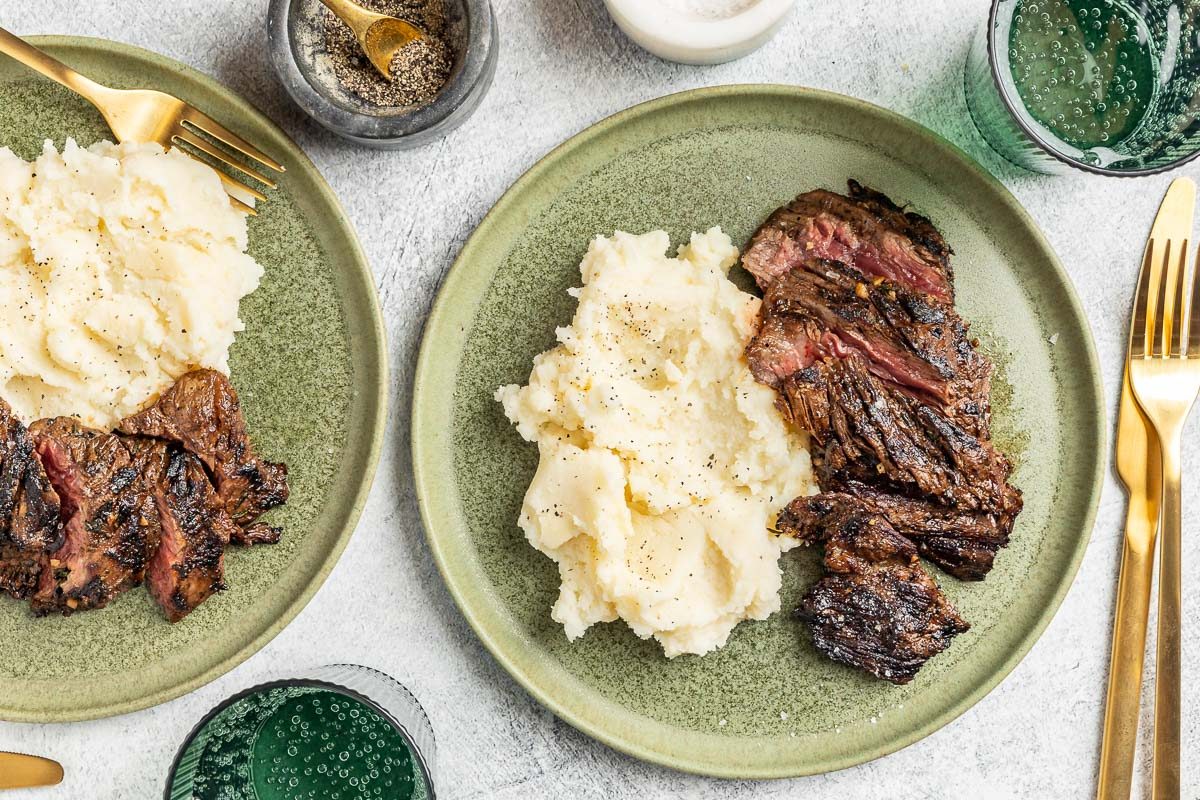 Hangar Steak plates with a side of mashed potatoes.