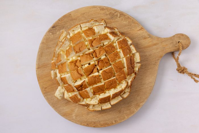 Hawaiian sweet bread being filled with cheese.