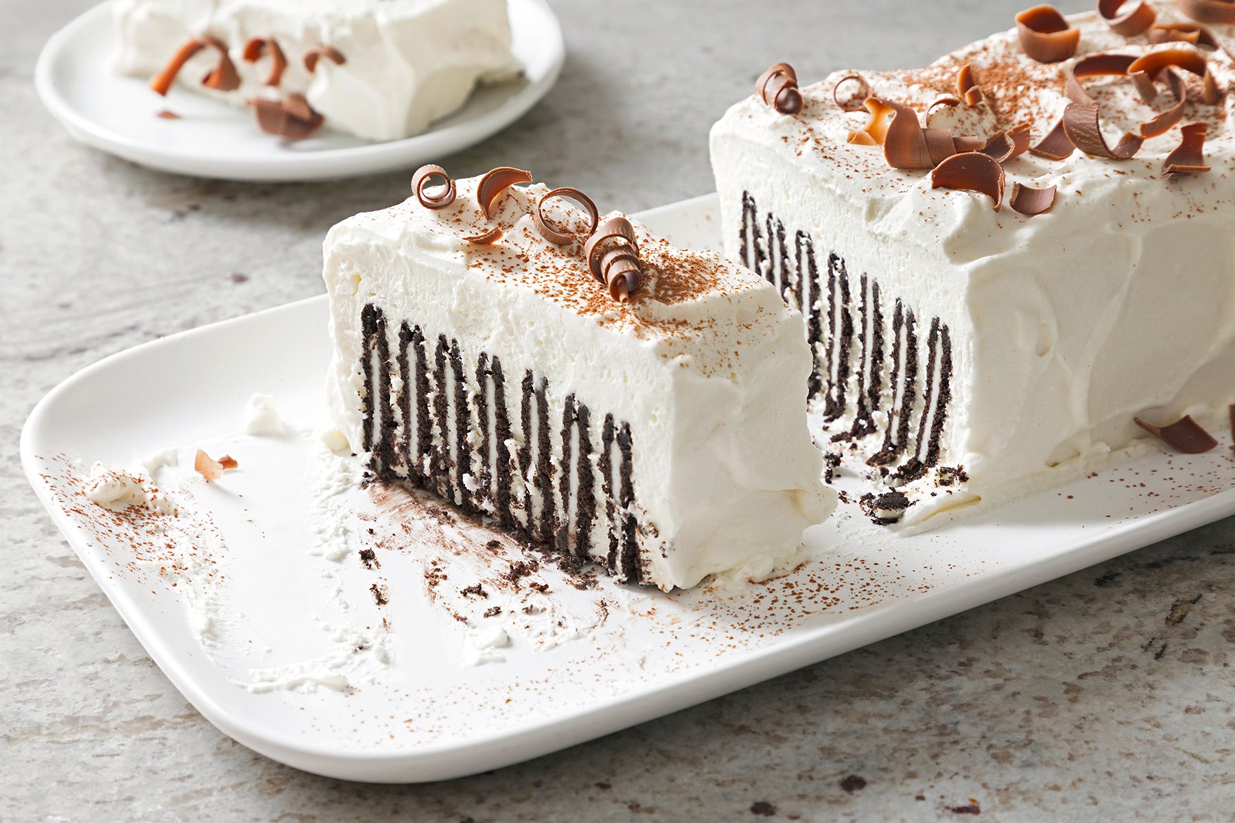 3/4th shot of icebox cake topped chocolate curls and cocoa powder