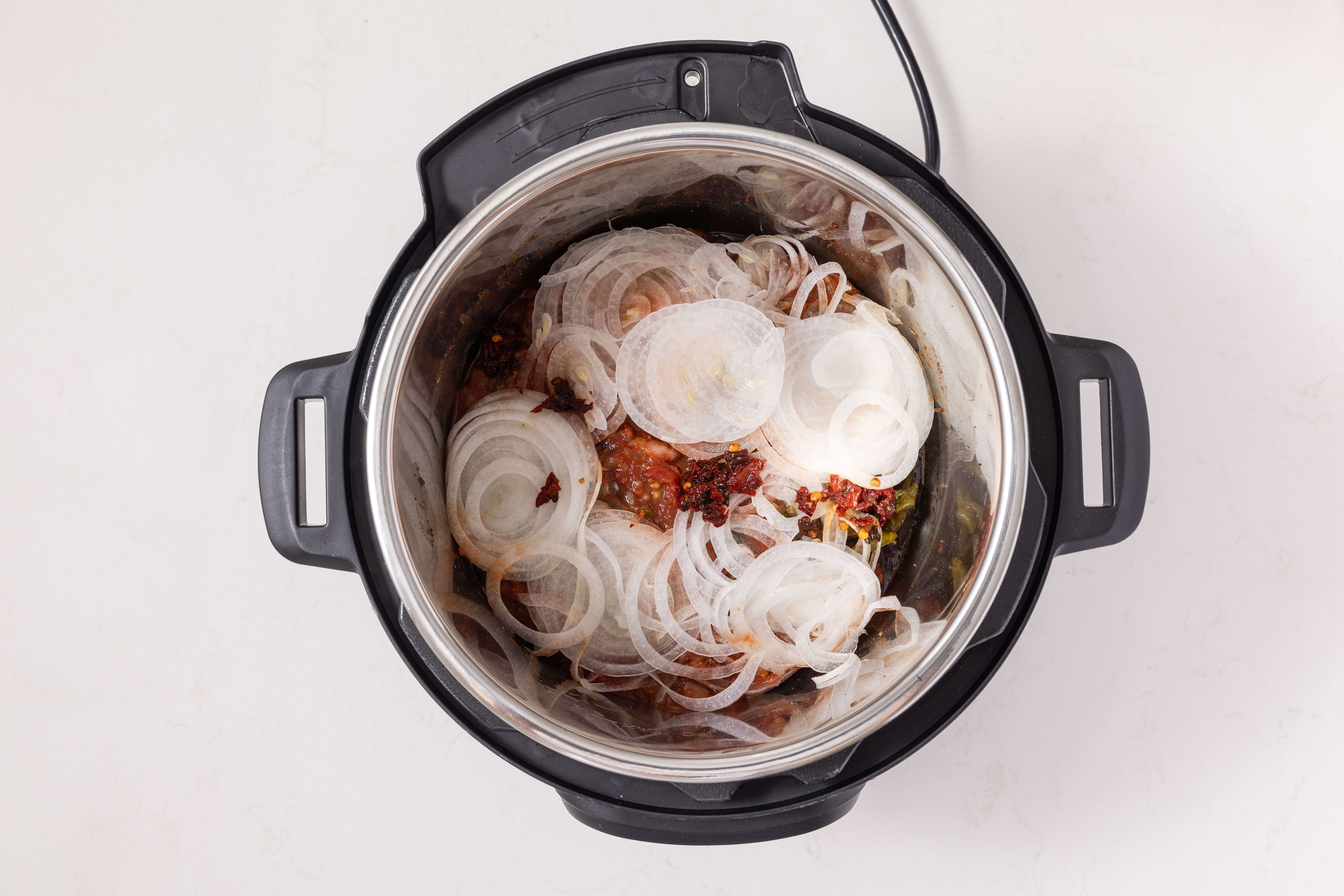 Onions, peppers and salsa added to instant-pot.