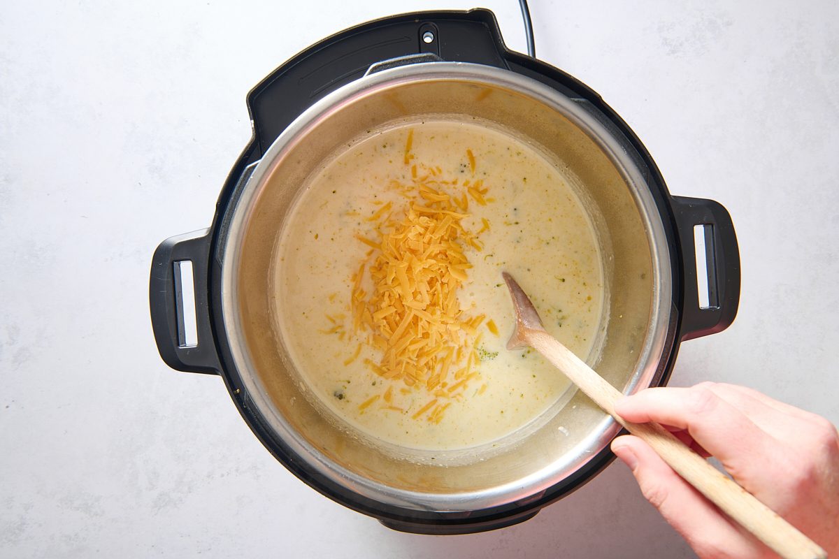 Stirring in the shredded cheese