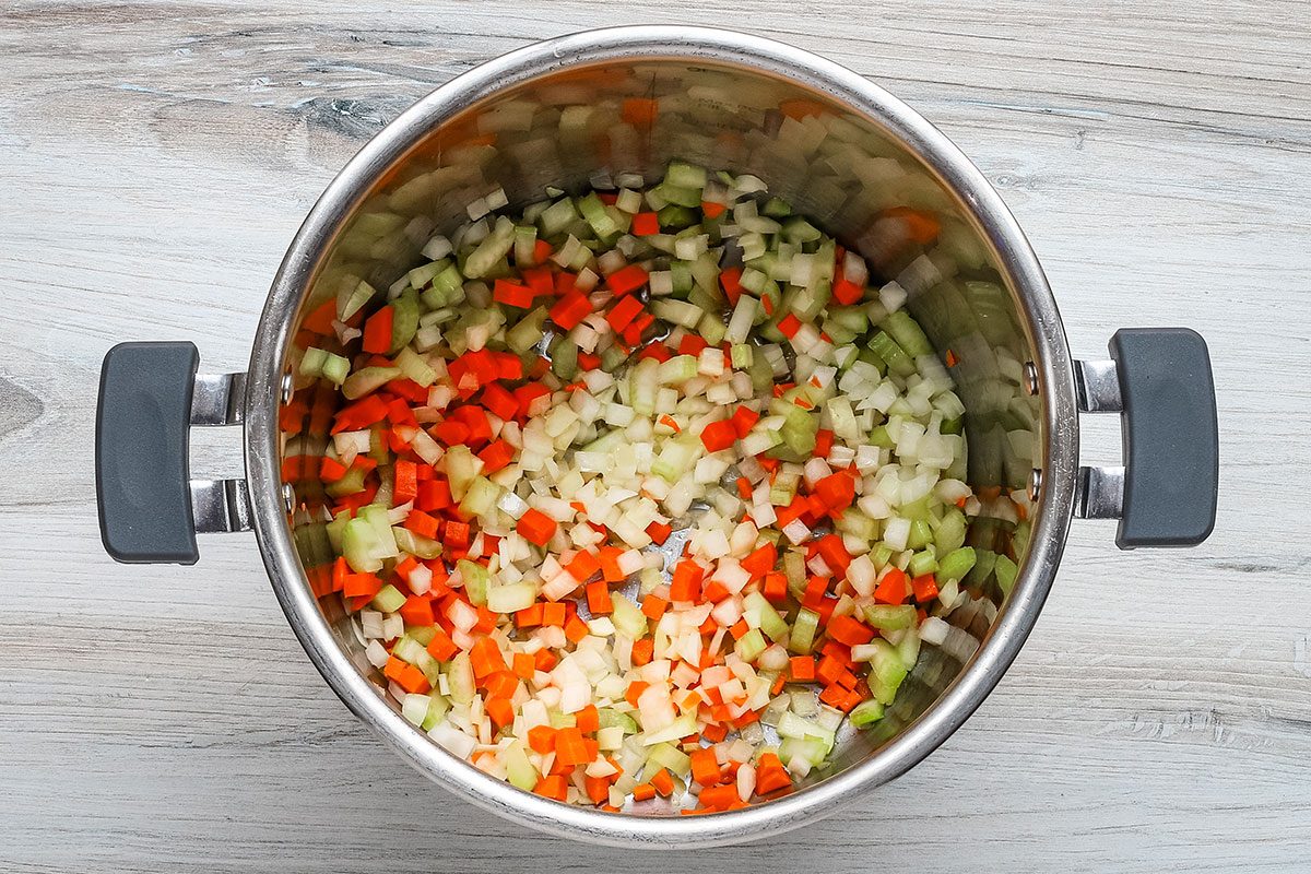 The aromatic vegetables in the Instant Pot to be sautéed for lentil soup.