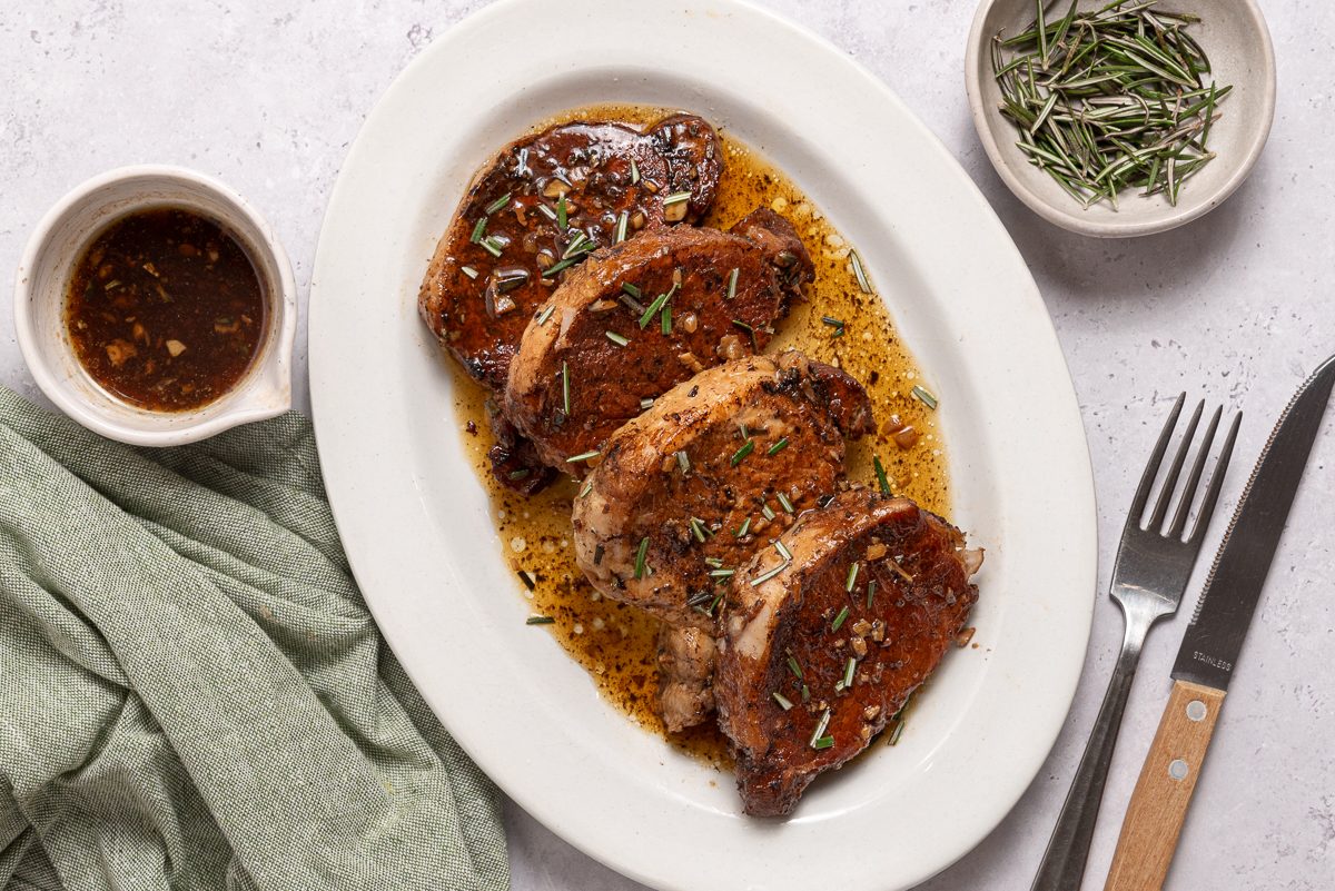 Instant Pot Pork Tenderloins On A Serving Plate With Sauce