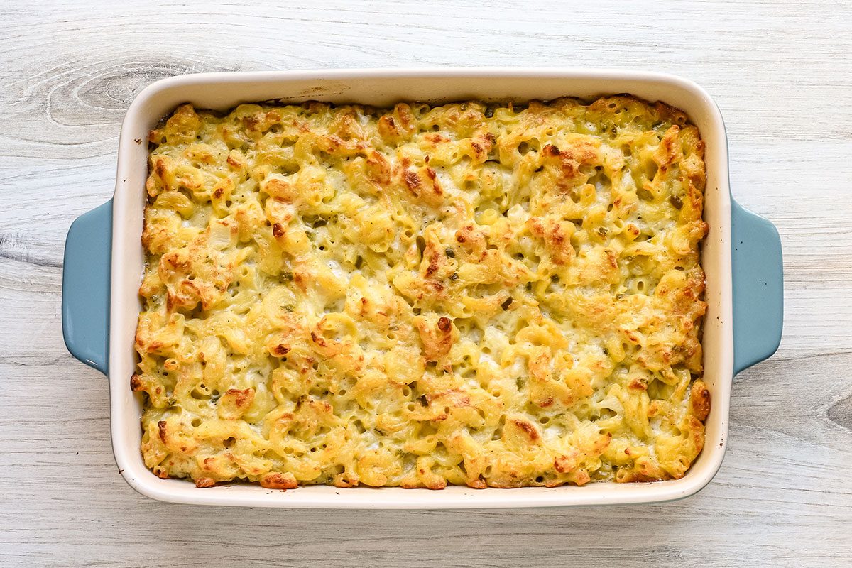 A pan of baked jalapeno mac and cheese, browned around the edges and creamy.