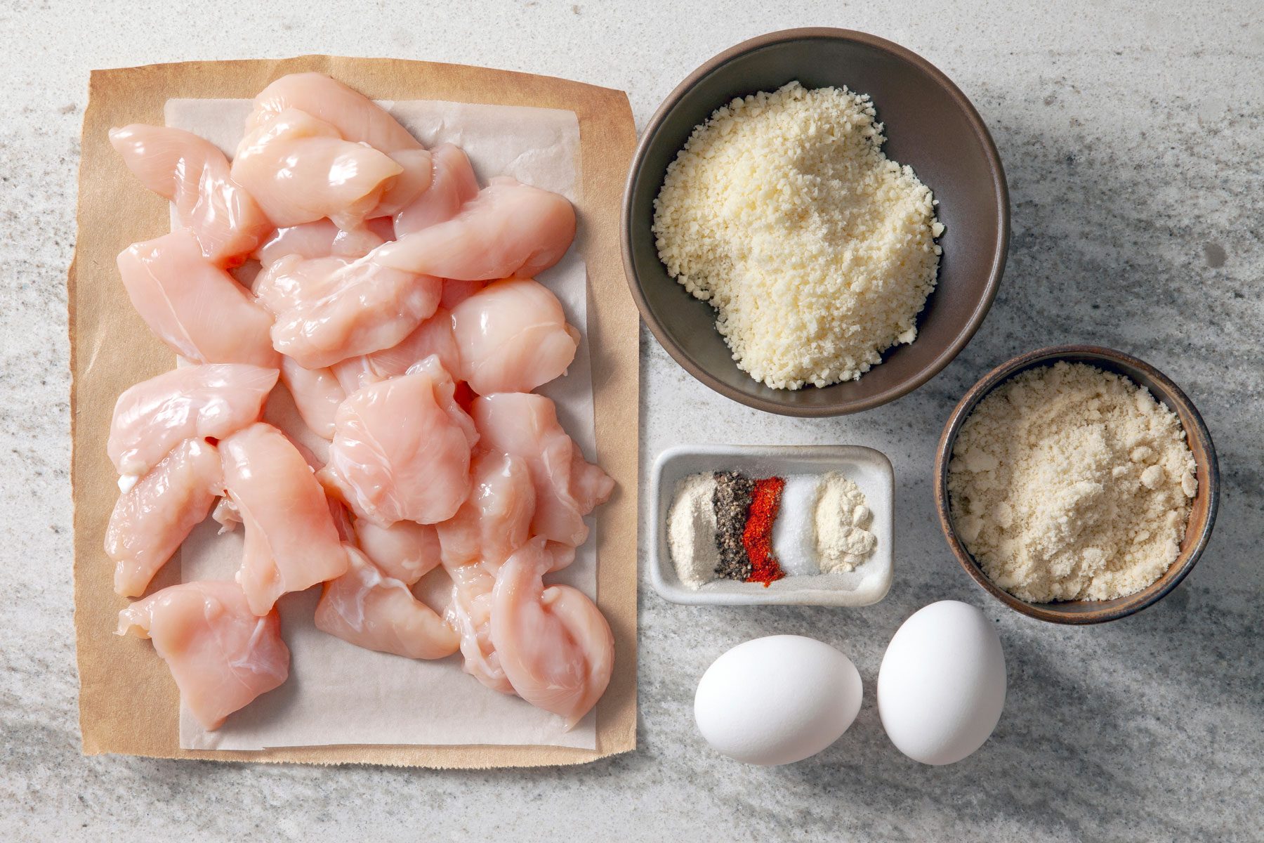 Eggs, almond flour, parmesan cheese, seasonings and chicken tenders.