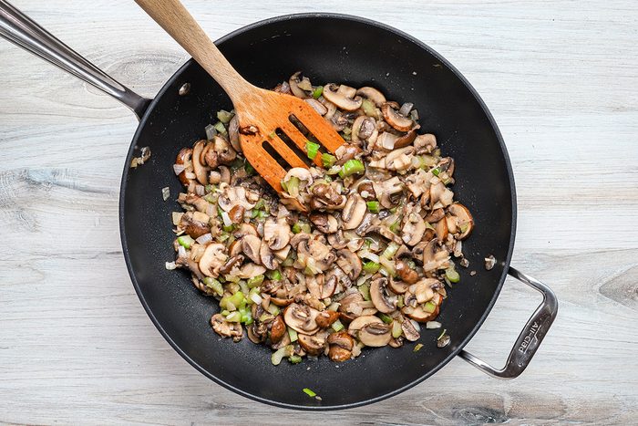 sautéing mushrooms, celery, and onions for keto stuffing, a Taste of Home recipe.