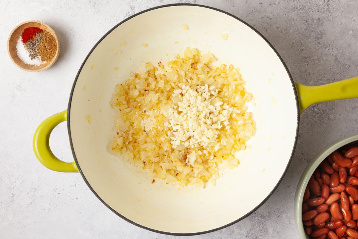 Step 1 of Taste of Home Kidney Beans is to heat the olive oil over medium heat. Add the chopped onion and cook until it softens and turns translucent, four to five minutes. Toss in the garlic and stir for another minute until fragrant.