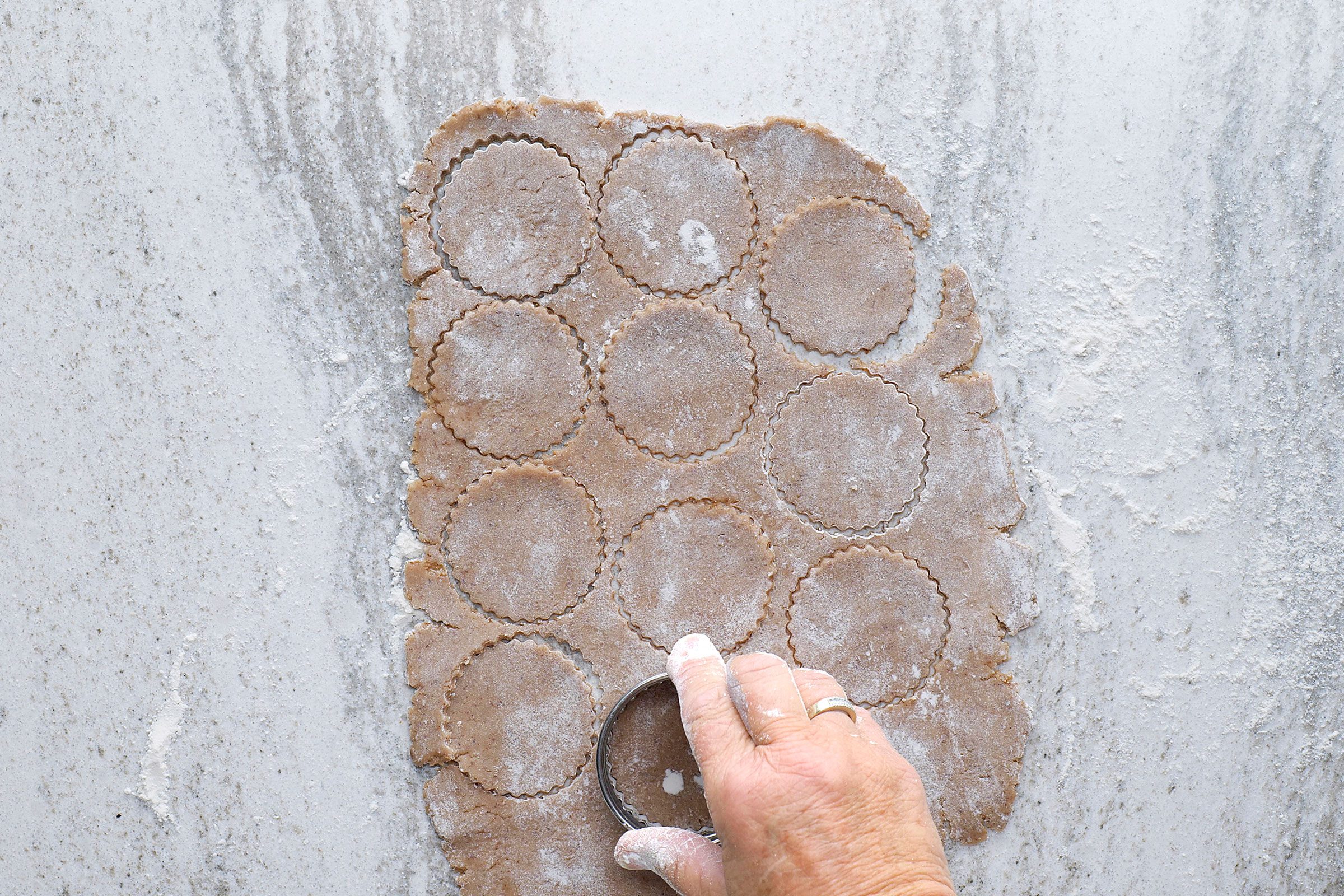 Cutting the rolled dough with a cookie cutter