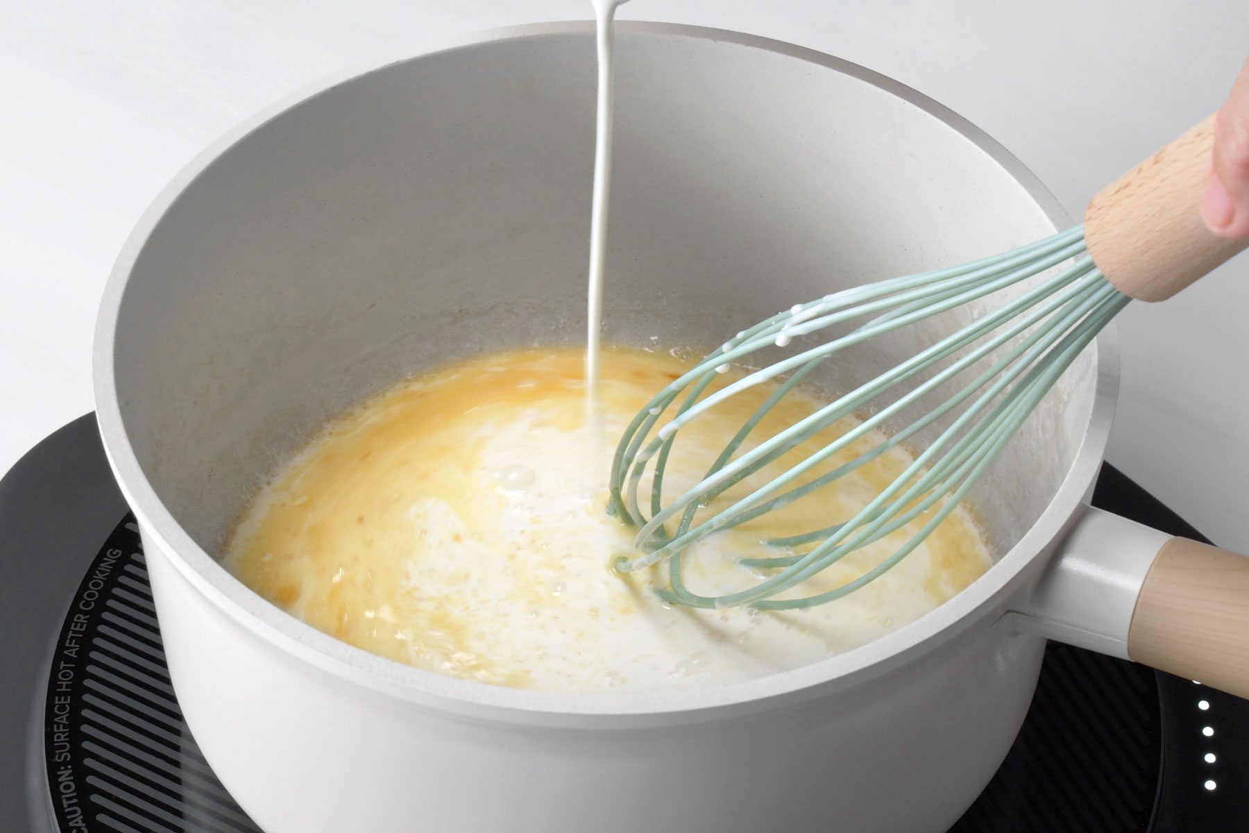 Half and half being added to cheese and flour mixture.