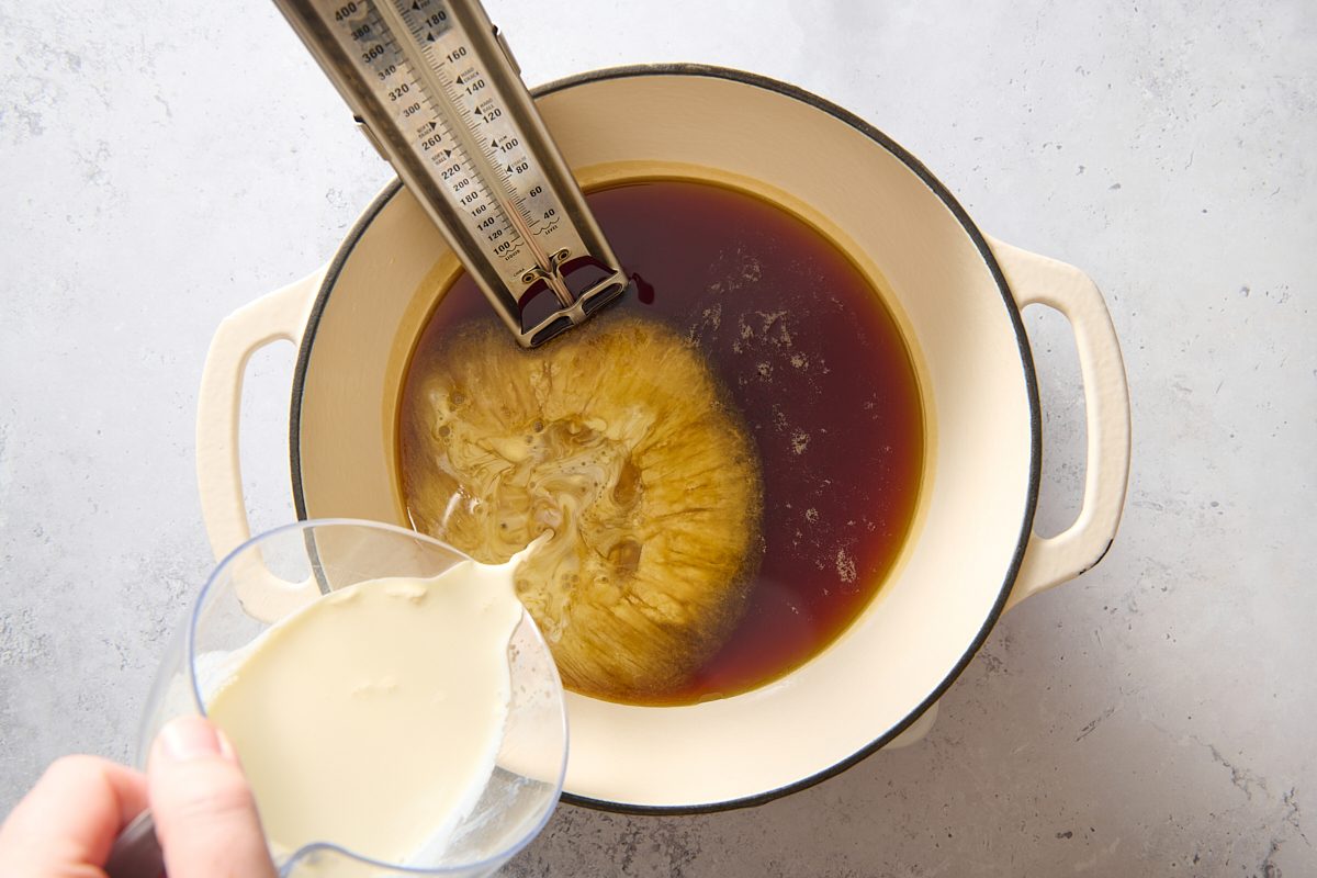 Pouring cream into the hot maple syrup
