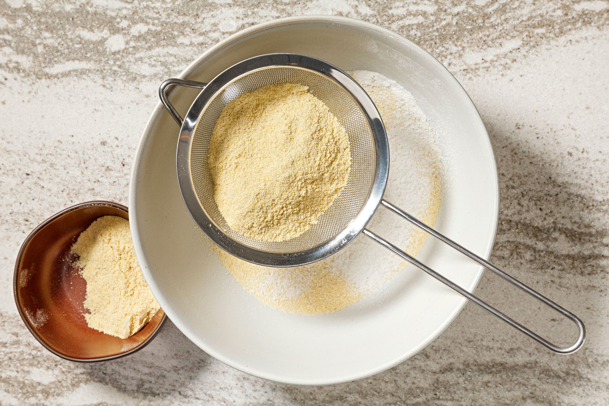 Sift masa harina, flour and salt into a large bowl.