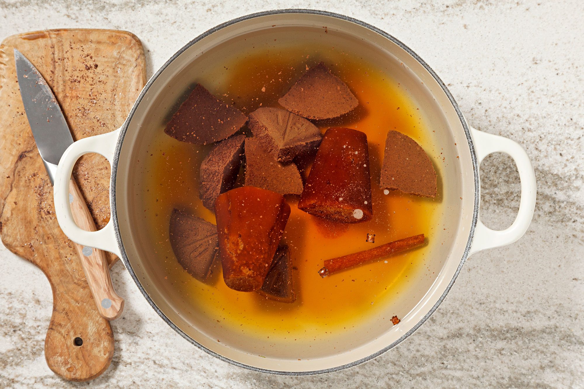 In a large saucepan over medium heat, combine remaining 2 quarts water, piloncillo, Mexican chocolate, cinnamon stick and cloves.