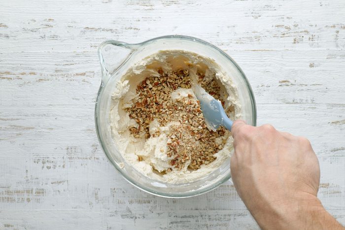 Folding pecans to butter, sugar and flour dough