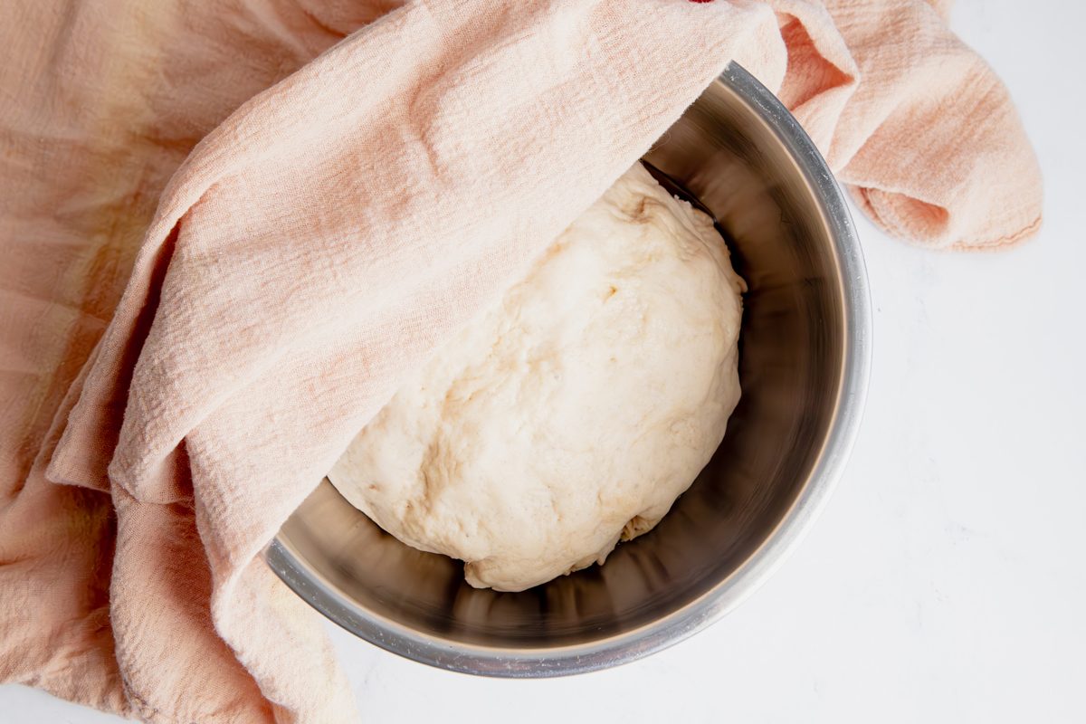 Oberhead shot for Taste of Home Mini Bread Loaf, bread doubled in size with linen on top.