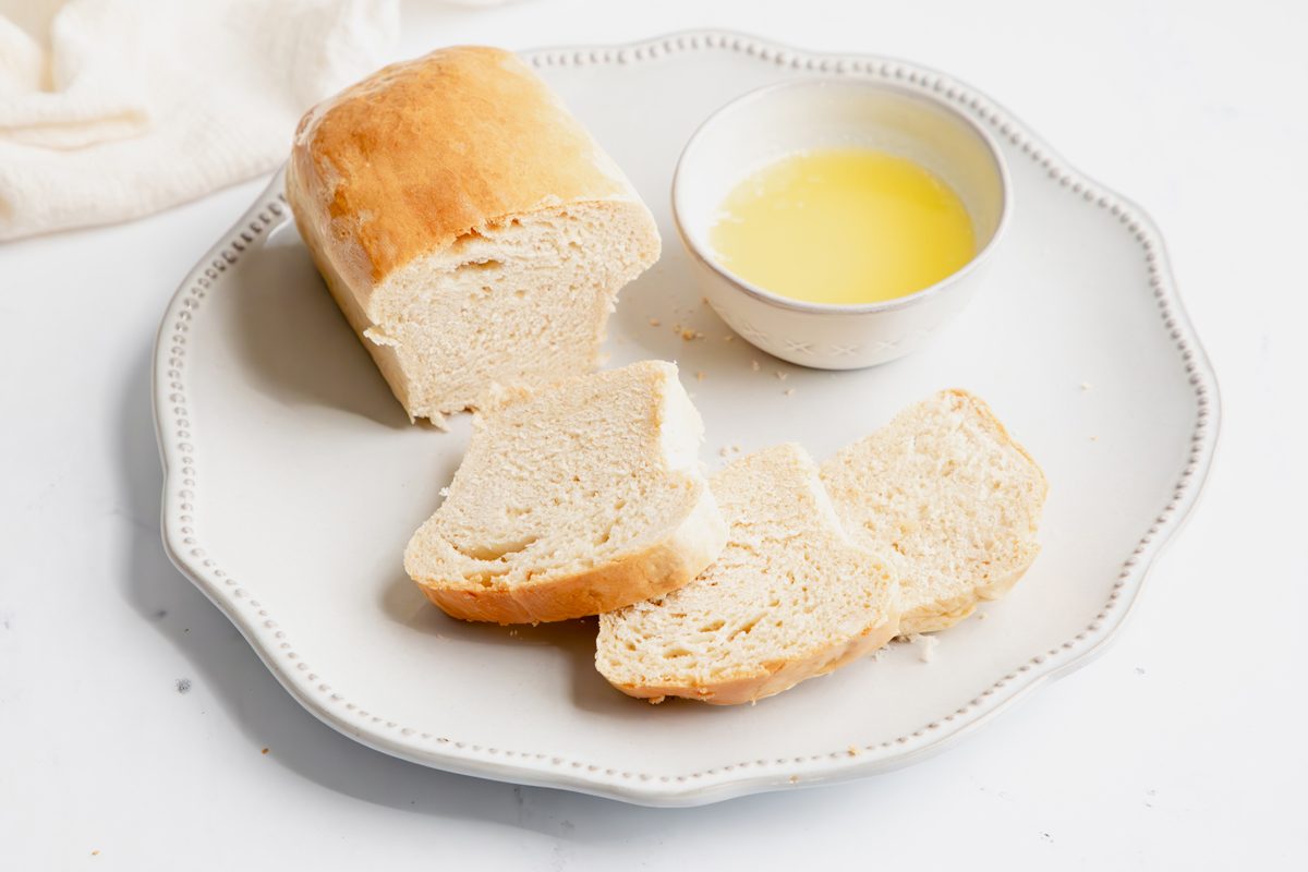 Close up beauty shot for Taste of Home Mini Bread Loaf, baked bread with melted butter on a plate.