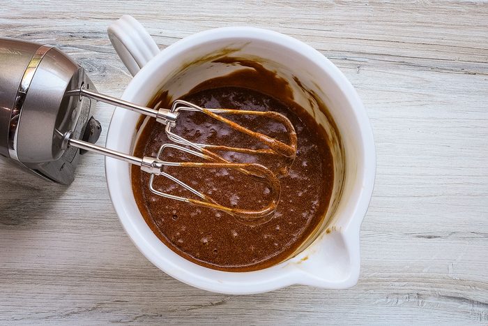 Dry ingredients and hot water are beaten into the molasses mixture for a molasses cake recipe.