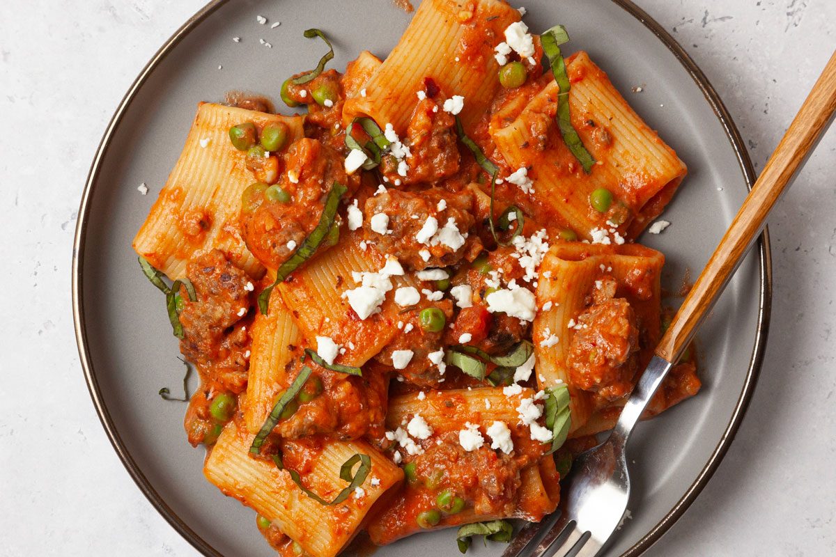 Single Servings Of Taste Of Home Pasta With Sausage and Peas Garnished With Feta And Basil