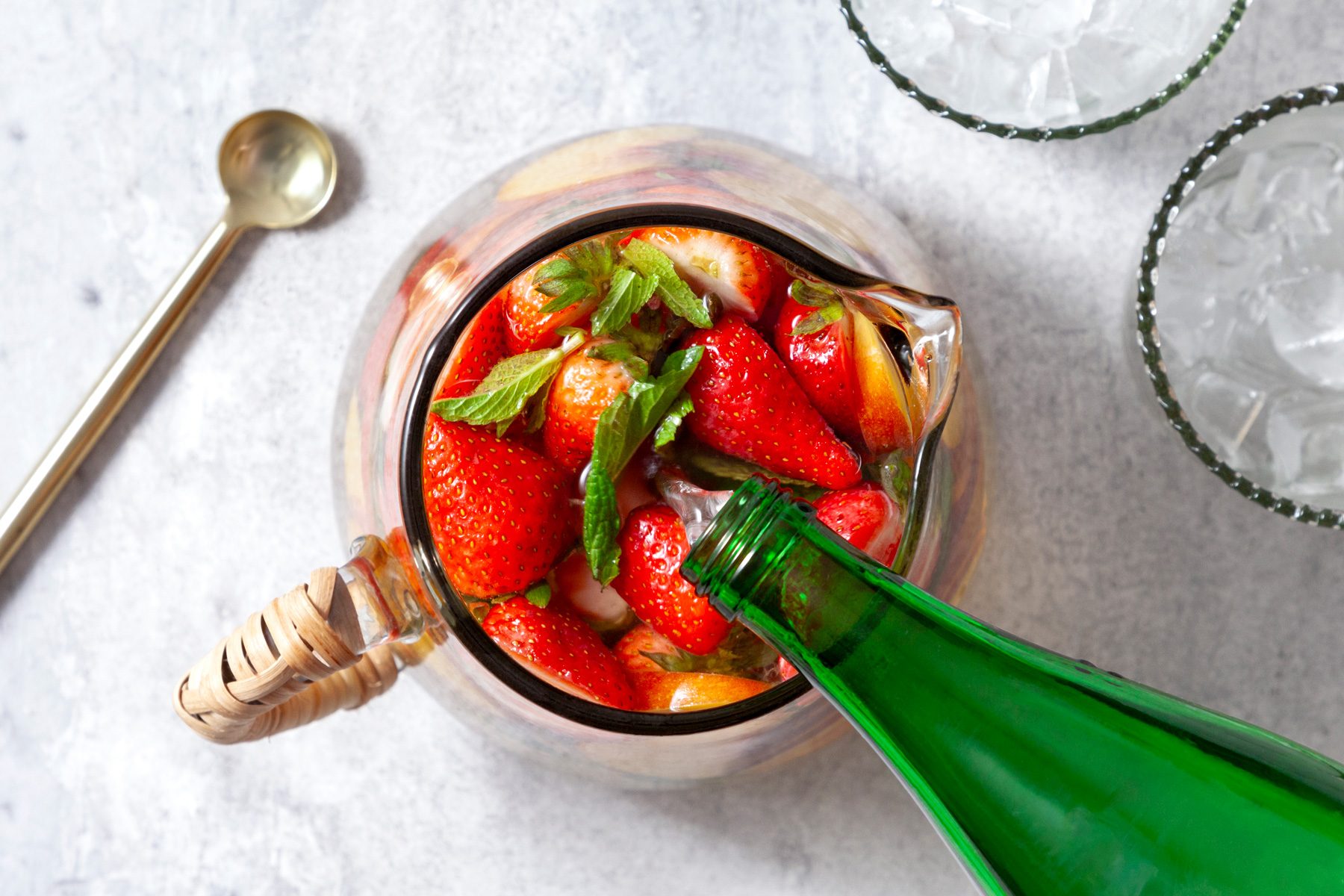 An overhead shot of liquor added in the pitcher.
