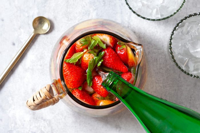 An overhead shot of liquor added in the pitcher.