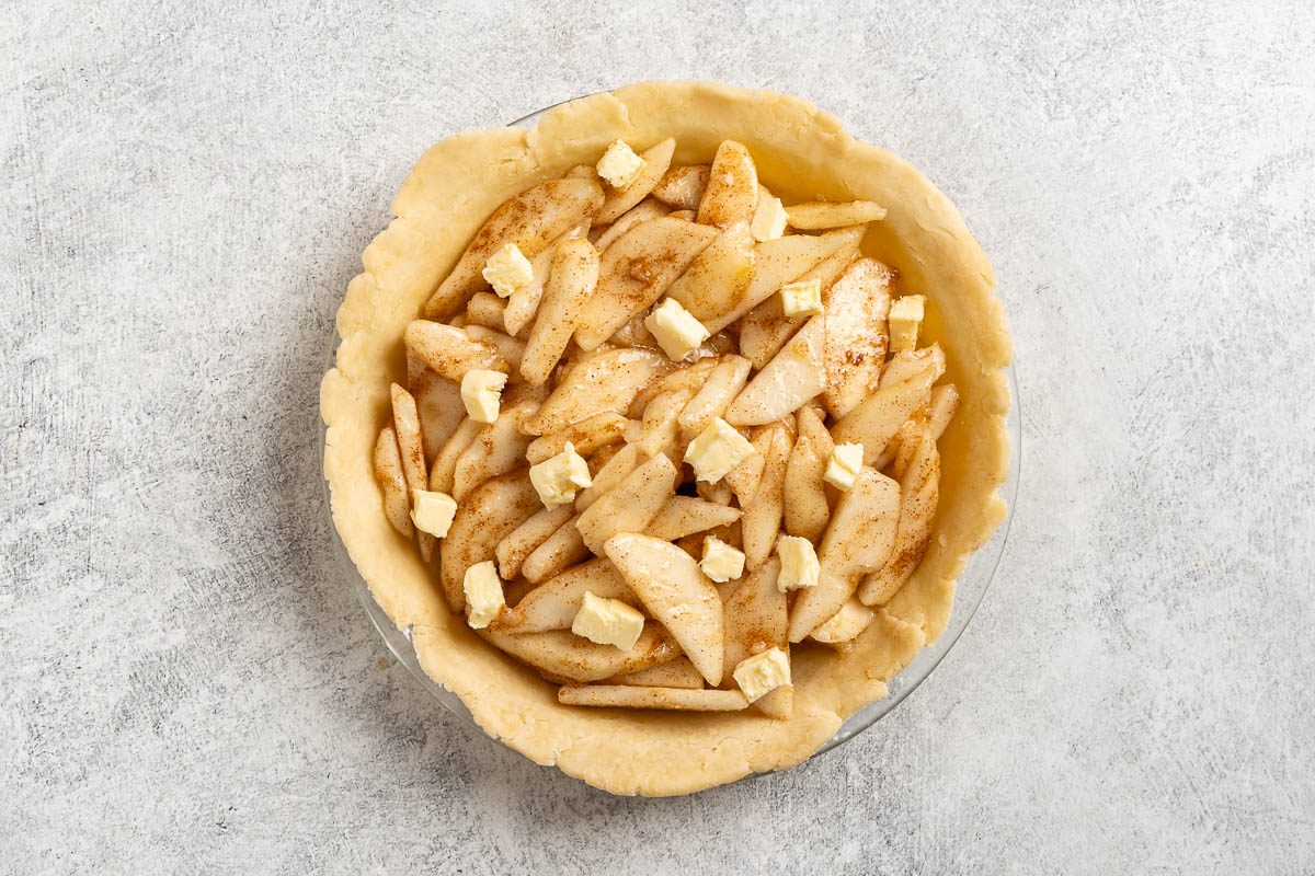 Taste of Home Pear Pie photo of the pear filling topped with butter.