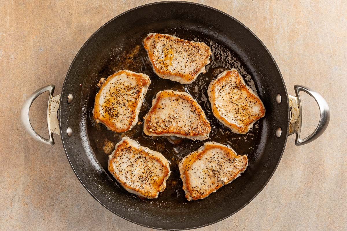 browning pork chops in a skillet