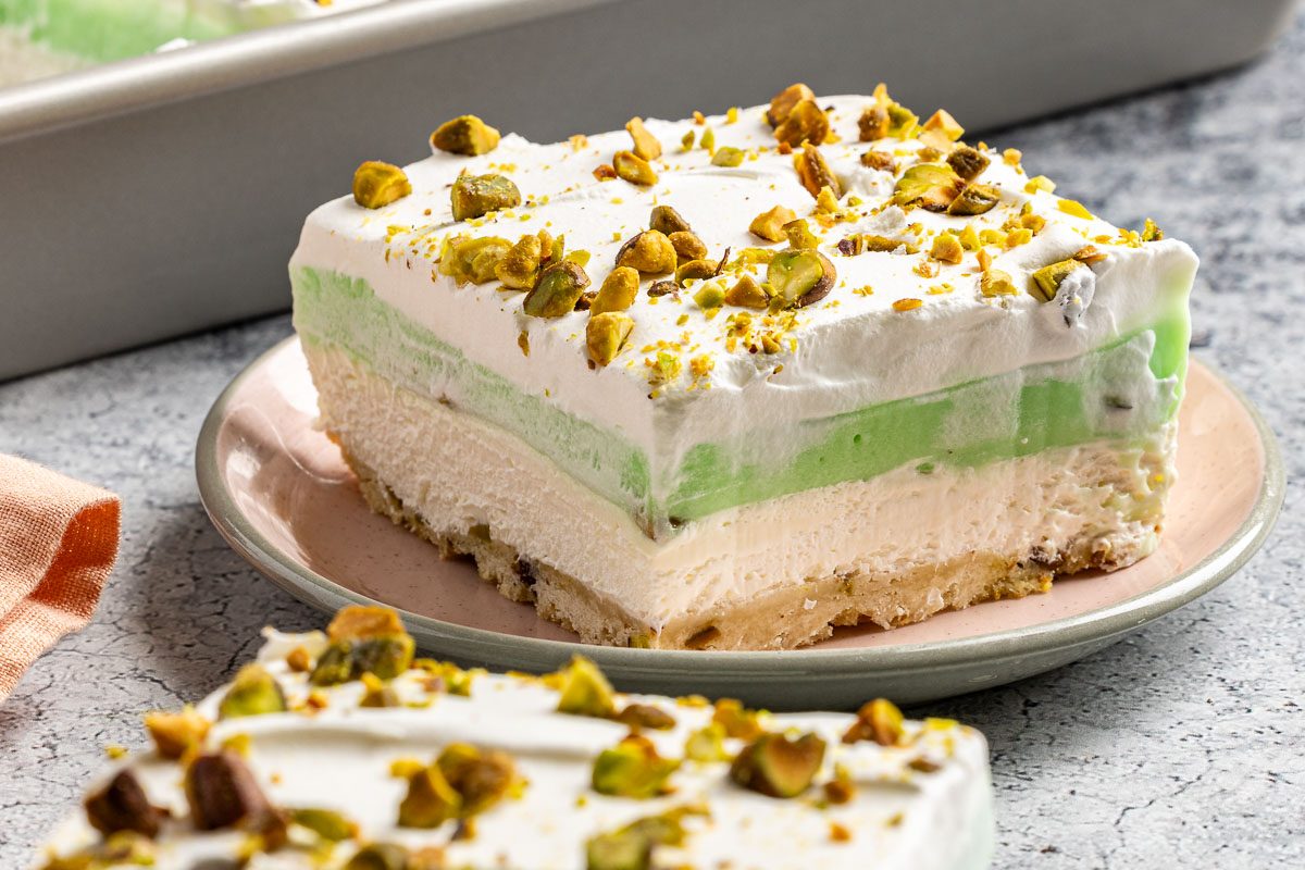 Taste of Home Pistachio Pudding Dessert photo of the finished recipe cut into slices and served on plates.