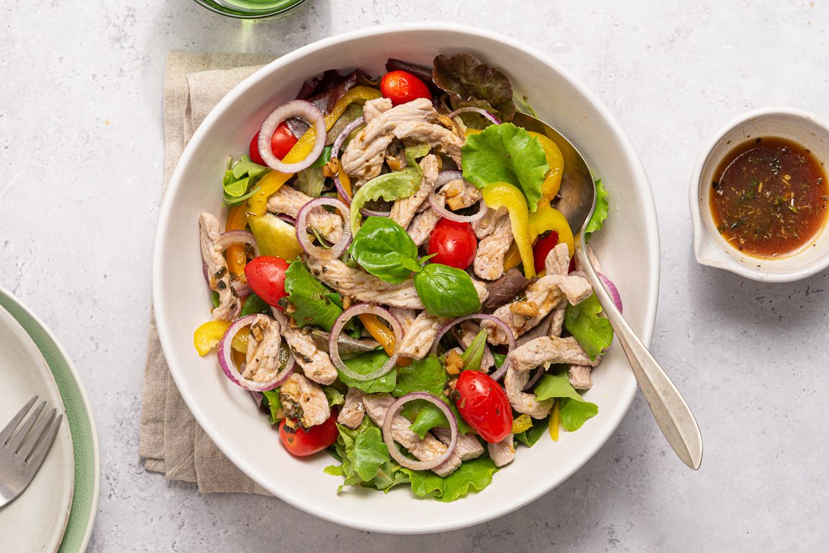 Pork Salad Inside White Bowl With Dressing
