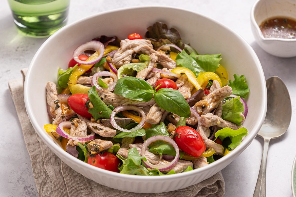 Pork Salad Inside White Bowl With Dressing