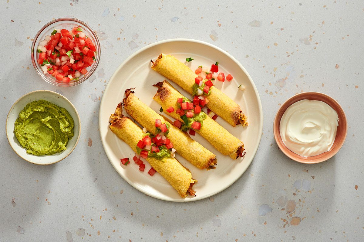 Taquitos served with guacamole pico de gallo and sour cream.