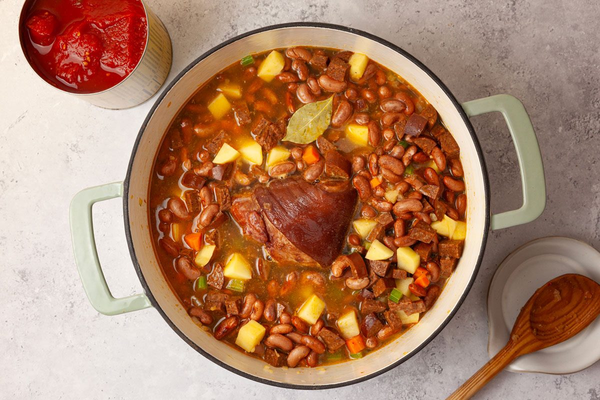 Step 2 of Taste of Home Portuguese Bean Soup is to add the rest of the ingredients except the kale and macaroni