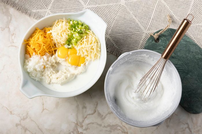 large bowl, combine the mashed potatoes, milk, cheeses, green onions, onions for Potato Souffle