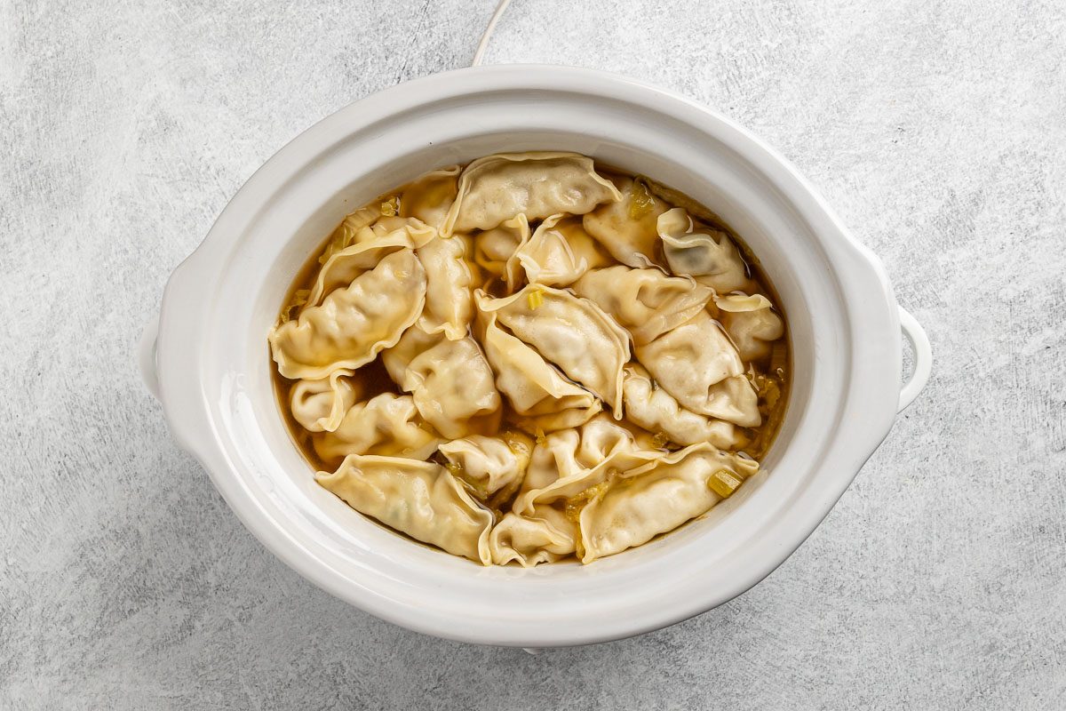 added potsickers to the slow cooker.