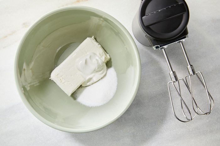 Cream cheese filling ingredients in bowl cream cheese sugar sour cream