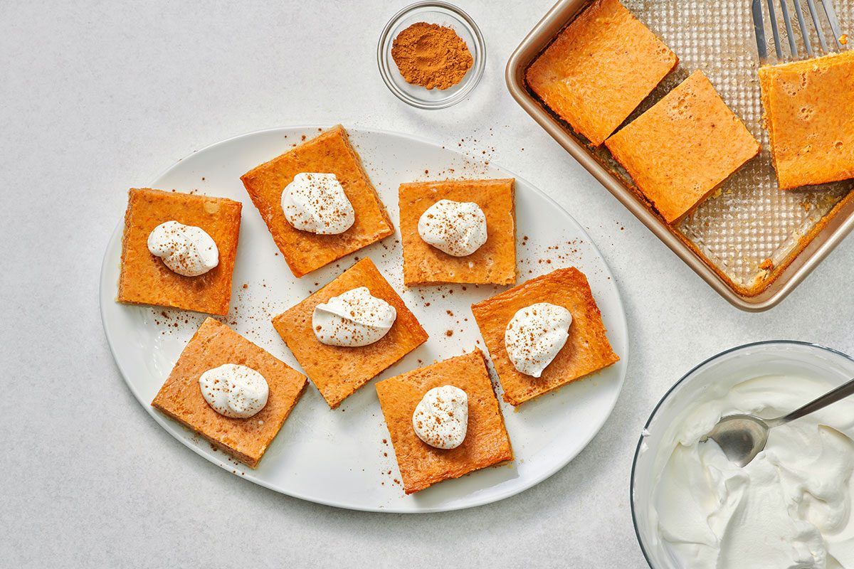 Pumpkin shortbread cut into bars and served with whipped cream